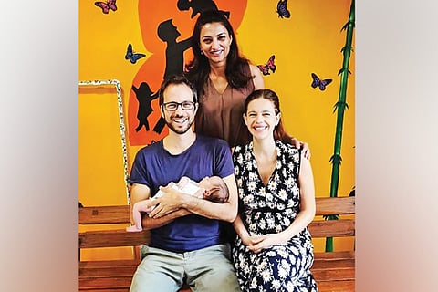 Kalki, her partner Guy Hershberg, and their new born girl Sappho, with their doctor