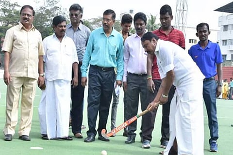 School Education Minister KA Sengottaiyan playing hockey during the inauguration of State level Hockey