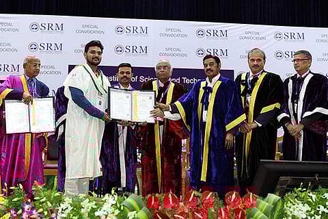 A student receives the degree certificate from SRM Chancellor TR Pachamuthu at the special convocation