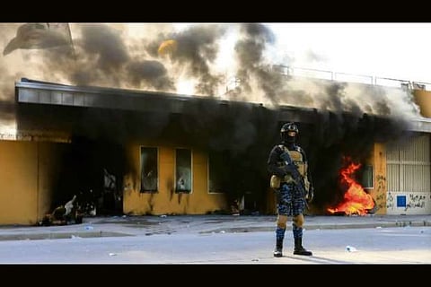 Rock-throwing Iraqi militias quit US Embassy after protests