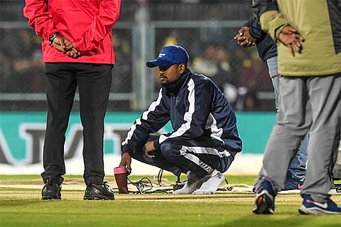 Ground staff in Guwahati use the hair dryer in an effort to get the ground in playing condition