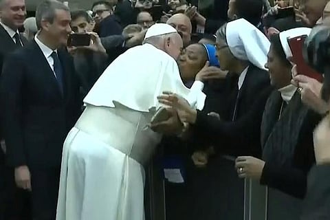 "Don't bite" Pope negotiates papal kiss after controversy