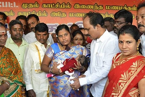 Kamatchi and Anbarasu with their newborn, Sindhu, at Woodlands Theatre on Thursday