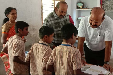 Vellore Collector A Shanmuga Sundaram interacts with students at a govt school in Katpadi