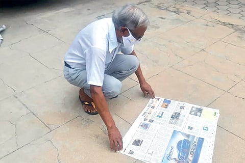 Dr Jacob John spreads newspaper outside his house to kill virus