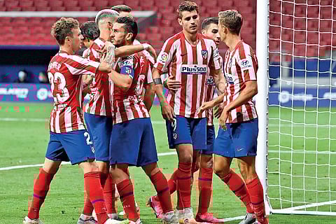 Alvaro Morata celebrates with his teammates after finding the net