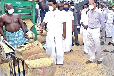 Food Minister Kamaraj speaks to a worker at the DPC at Ullikkottai near Mannargudi in Tiruvarur on T