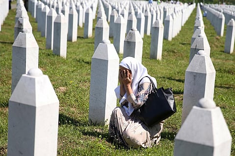 A woman cries at a graveyard, ahead of a mass funeral in Potocari near Srebrenica July 11 (Reuters)