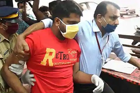 Police personnel produce Sarith, accused in gold smuggling case at a special court