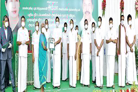 Chief Minister distributing welfare assistance to a beneficiary in Erode on Friday