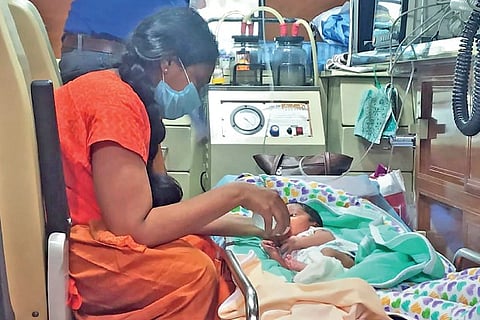 Mother feeds the baby inside the ambulance on way to Vellore