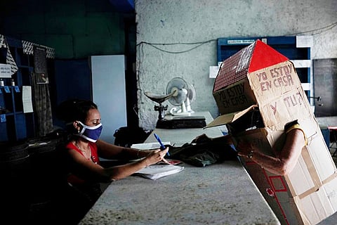Retired nurse wears full-body cardboard shield against coronavirus
