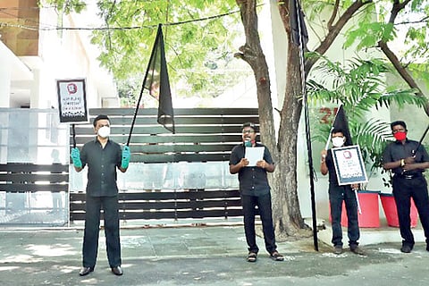 DMK president with party cadre, stages a black flag protest against domestic electricity charges