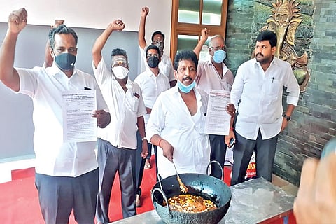 Functionaries of Tamil Nadu State Sand Lorry Owners? Federation shout slogans after preparing halwa