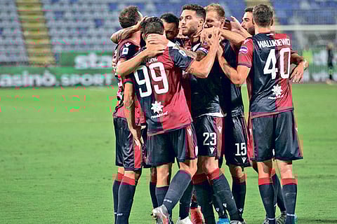 Cagliari players celebrate their success over Juventus