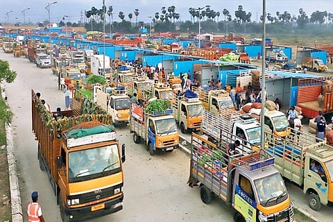 Trucks laden with goods outside the market