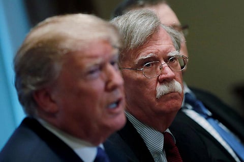 Trump alongside Bolton. File Photo
