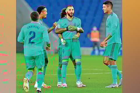 Karim Benzema (centre) is congratulated by his team-mates