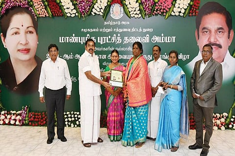 Chief Minister handing over the Avvaiyar award to Kannagi, a social reformer from Tiruvannamalai on Monday