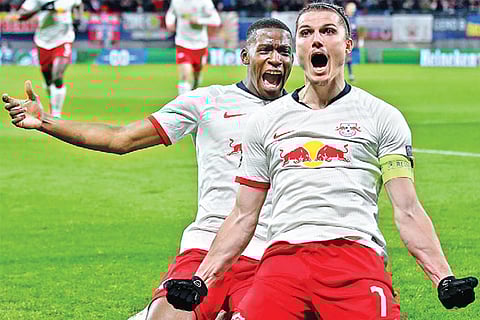 Leipzig players celebrate their win over Tottenham Hotspur in Champions League