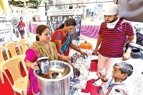 Family members serve juice at stall