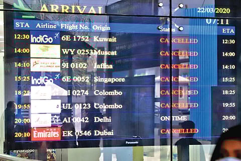 A flight information board at the airport on Sunday