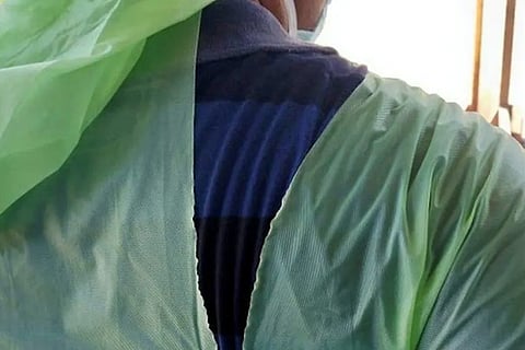 A doctor wearing a torn raincoat at a major coronavirus disease treatment facility in Kolkata