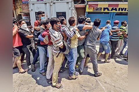 People outside a liquor shop in Delhi on Tuesday