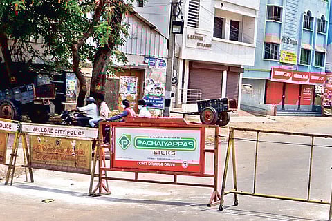 The barricade placed on arterial Arcot Road near Kagithapattarai in Vellore town on Tuesday