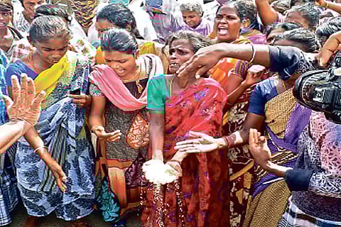 Women stage protest on a road near Kollidam in Tiruchy on Friday