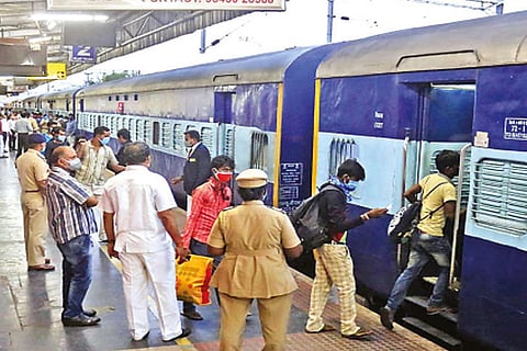 Migrant workers boarding a special train at Coimbatore railway station on Friday