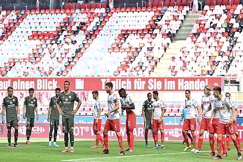 Players of FC Koln and Mainz wait for a corner kick during a Bundesliga match