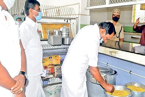 Minister KA Sengottaiyan checking food at an Amma Canteen in Erode on Sunday