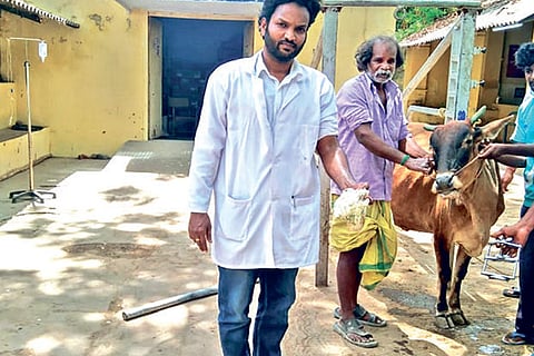 Dr Ravi Sankar with the plastic bag removed from the cow which is seen with its owner