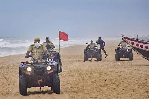Odisha Marine police patrol a beach to prevent tourists, fishermen from venturing into the sea