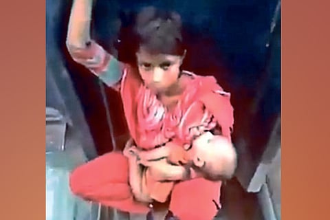 Detect: Woman sitting between train carriages not from India