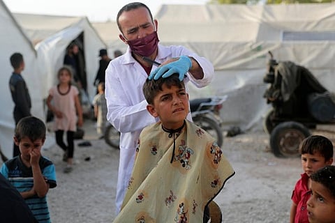 In Syria's war-torn Idlib, travelling barbers bring children relief