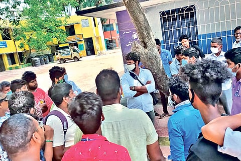 Temporary COVID-19 combat duty workers demand payment of salaries during a gate meeting