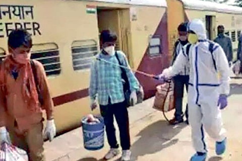 Migrant workers from Chennai being sprayed sanitisers