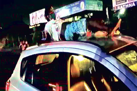 A screengrab showing Ranjithkumar atop the car roof