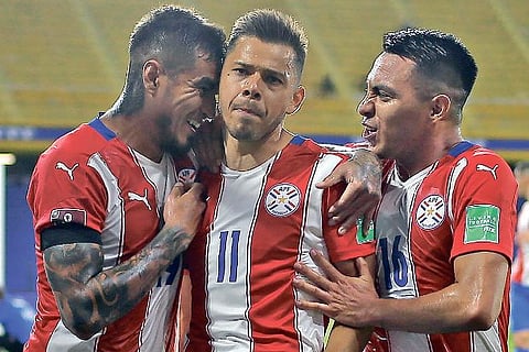 Paraguay players celebrate the opening goal against Argentina