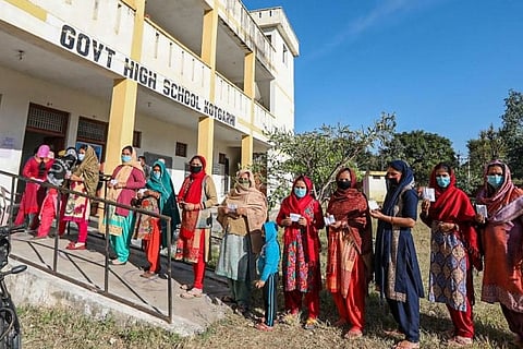 West Pakistani refugees wait to cast their votes for the DDC elections in Jammu district