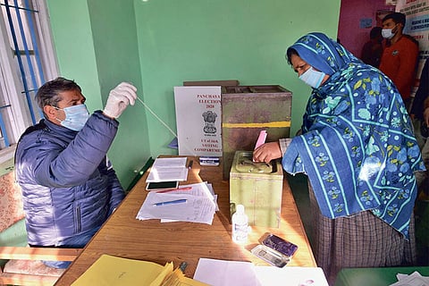 A woman casts her vote at Gund on Saturday