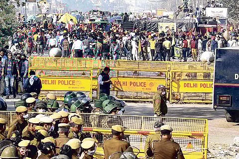 Police stand guard near a barricade in Delhi