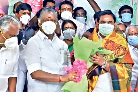 Chief Minister Edappadi K Palaniswami being congratulated by Deputy CM O Panneerselvam after the announcement