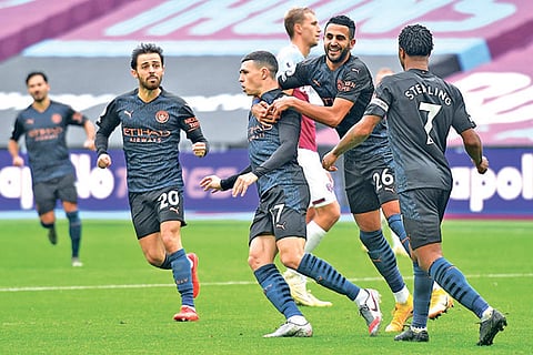 Manchester City players celebrate Phil Foden's equaliser against West Ham United