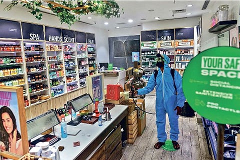 Staff sanitising shops inside a mall in the city on Tuesday
