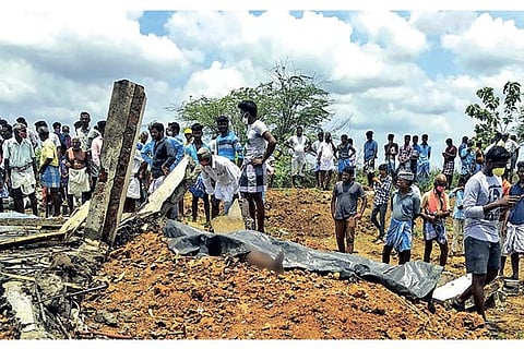 Locals gather near the factory after the blast in Cuddalore on Friday