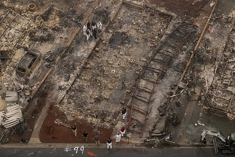 Search on for bodies in charred path of wildfires, Trump to visit California