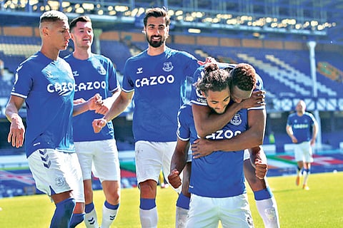 Dominic Calvert-Lewin celebrates a Premier League hat-trick against West Brom with his Everton team